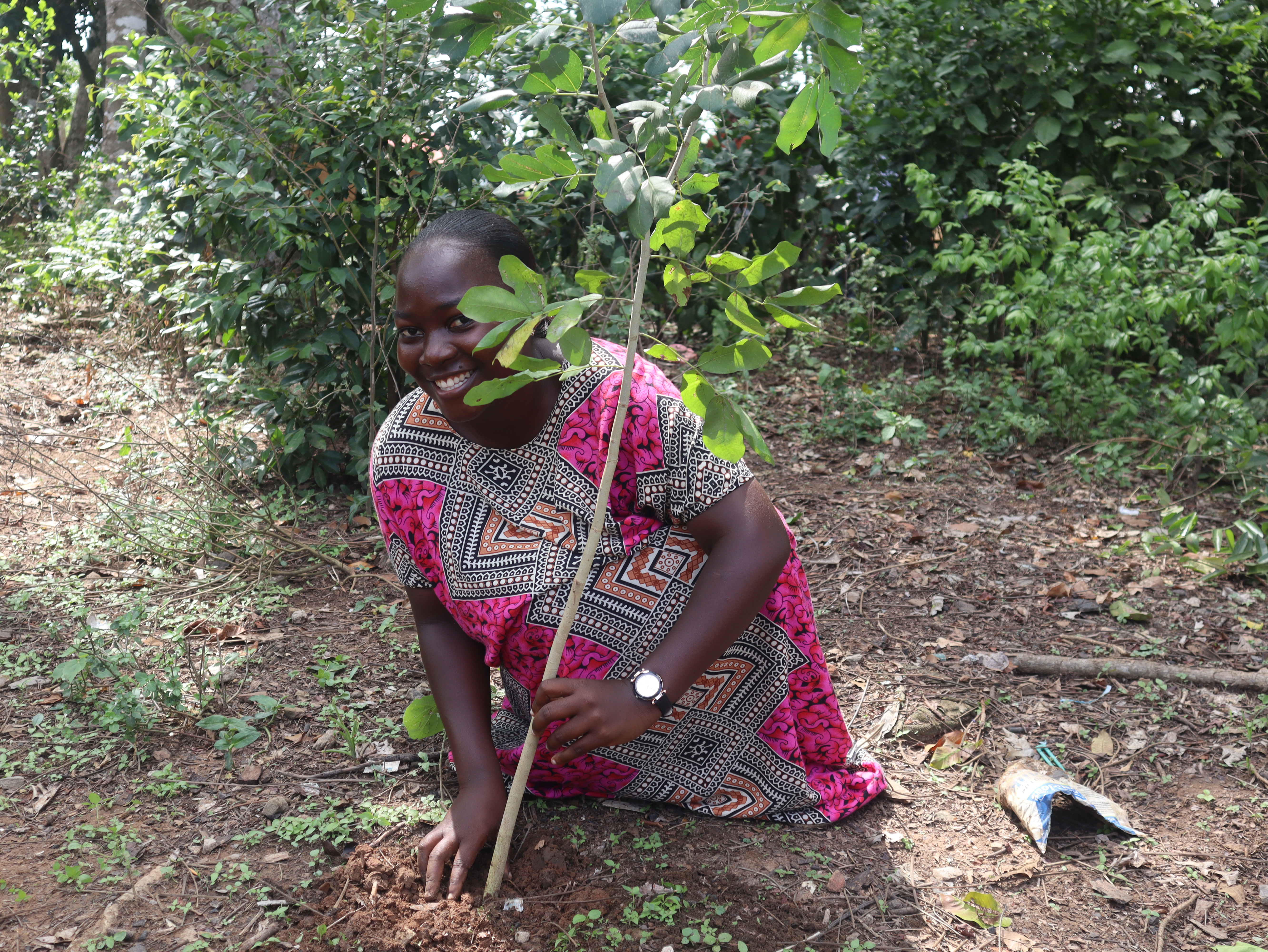 A young woman embracing her role in restoring natural sacred fores- Kaya Rabai in Kilifi County.